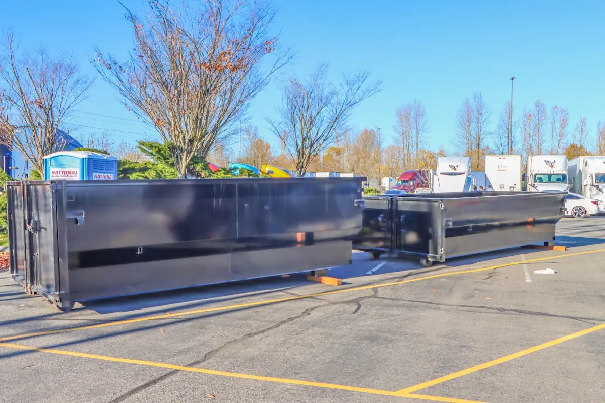 Professional dumpster rental service with roll-off container on residential driveway in Silvis